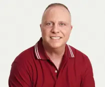 author Michael Caputo in a red with small white accent polo shirt